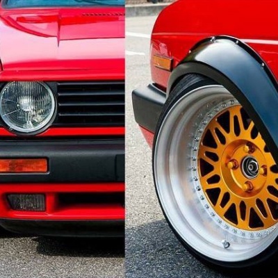 Carro desportivo vermelho com jantes douradas e guarda-lamas pretos