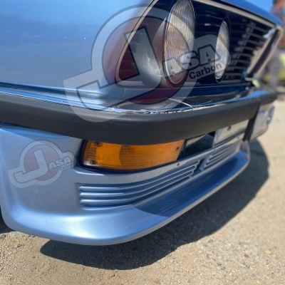 Frontal inferior de carro azul com pára-choques preto e luz amarela