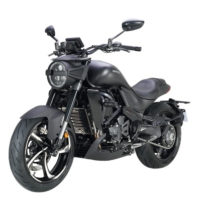 motocicleta preta com farol circular e pneus largos