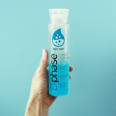 Frasco translúcido com líquido azul e texto Bphase