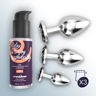 Frasco de lubrificante à base de água com três plugs anais metálicos de diferentes tamanhos