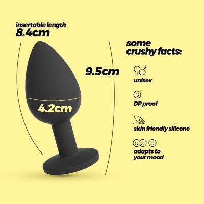 Plug anal preto com medidas e descrições em fundo amarelo