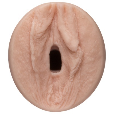 Objeto redondo cor de pele com textura detalhada e orifício central