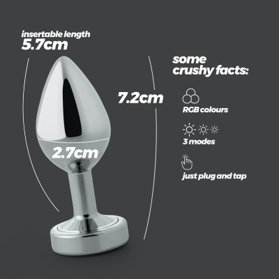 Plug anal metálico prateado com texto explicativo e dimensões