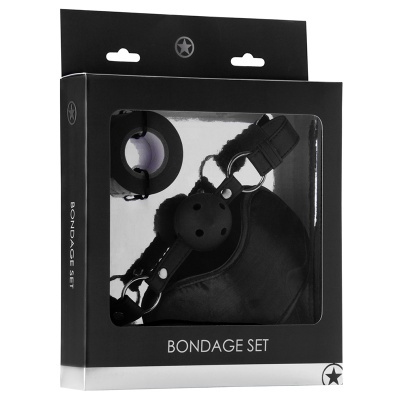 Conjunto bondage com algemas, venda e mordedor numa caixa preta