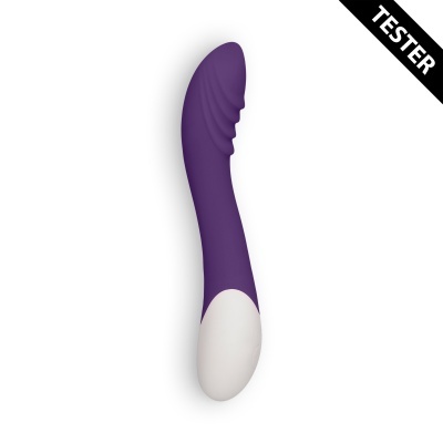 Vibrador roxo com branco curvado e ranhuras com etiqueta 'TESTER'