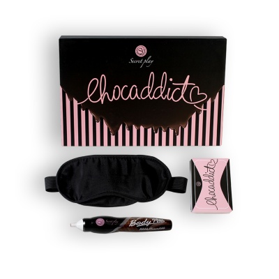 Conjunto de produtos com caixa preta e rosa, venda preta, tubo e pequena caixa rosa com texto chocaddict
