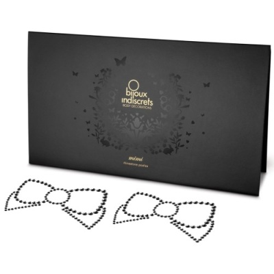 Conjunto de acessórios para o corpo com padrão de laço e embalagem preta marcada.