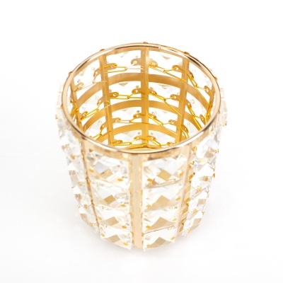 Porta-velas metálico dourado com painéis transparentes facetados