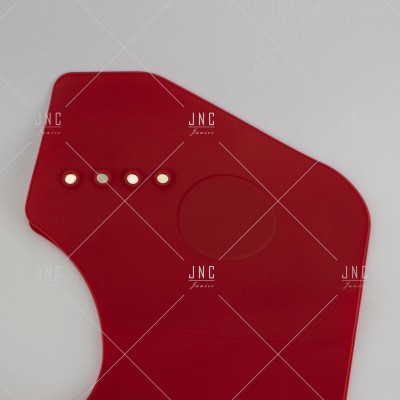 Produto vermelho em plástico com quatro orifícios e padrão circular