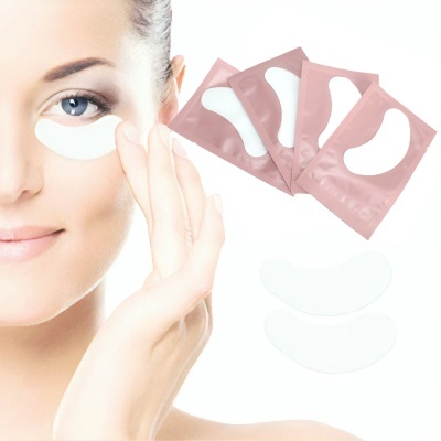 mulher com patch branco sob o olho e sachês rosa com patches de meia-lua