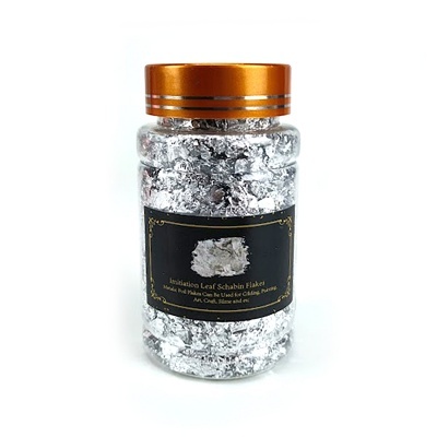 Frasco com flocos prateados para decoração com tampa dourada