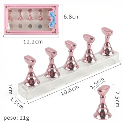 Conjunto de cinco suportes metálicos rosa em base transparente com dimensões e peso indicados.