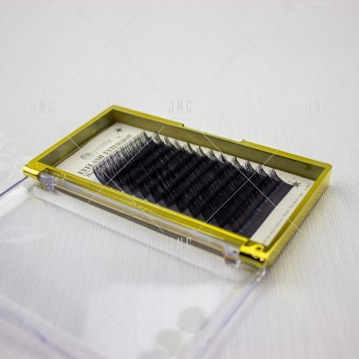 Caixa com pestanas postiços pretos em caixa de plástico com moldura amarela