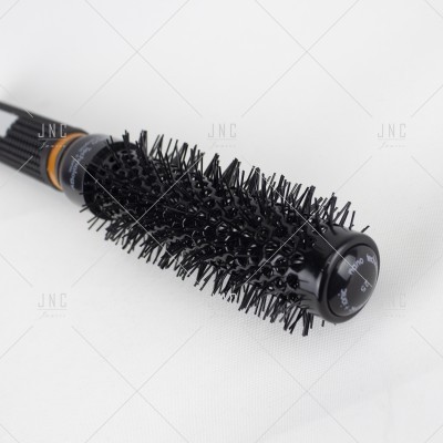 Escova de cabelo redonda preta com cerdas sintéticas e cabo texturizado