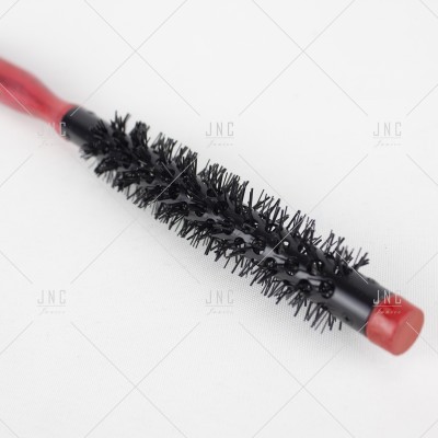 Escova de cabelo redonda preta com cabo vermelho