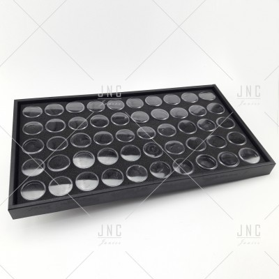 Caixa preta com múltiplas cavidades circulares e tampas transparentes