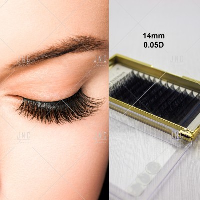 Olho com pestanas postiços e caixa com pestanas individuais pretas.