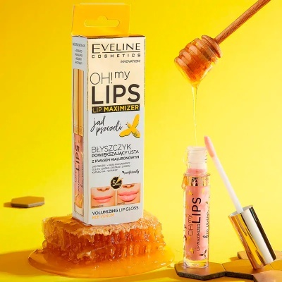 Gloss labial Eveline OH! my LIPS Lip Maximizer com mel e favo de mel em fundo amarelo