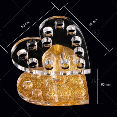 Suporte acrílico em forma de coração com base dourada e inserções transparentes