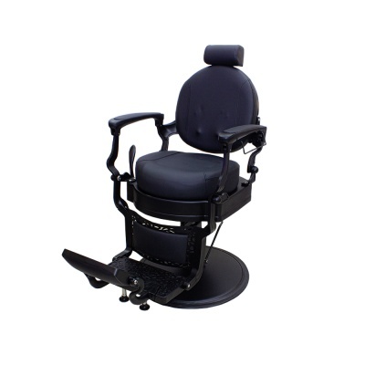 Cadeira de barbeiro preta com estofos em couro e apoio para pés.
