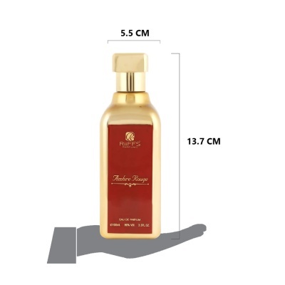 Frasco de perfume dourado com rótulo vermelho