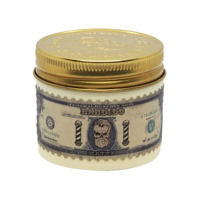 Recipiente creme com tampa dourada e rótulo tipo bilhete dólar com rosto barbudo e texto DANBIDO