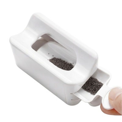 Dispositivo branco com esferas pretas num compartimento deslizante