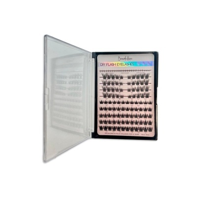 Caixa transparente com pestanas postiços pretos organizados em filas