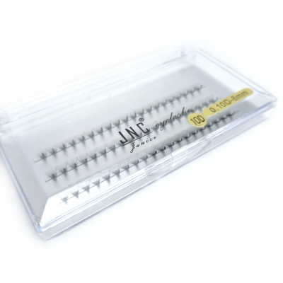 Caixa transparente de pestanas falsas JNC com texto e etiqueta amarela.