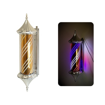 Barbeiro giratório metálico com cilindro laranja e faixas brancas, iluminado com luzes LED.