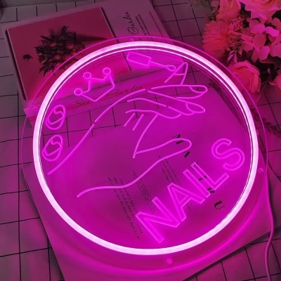 Neon rosa circular com desenho de mão e palavra nails