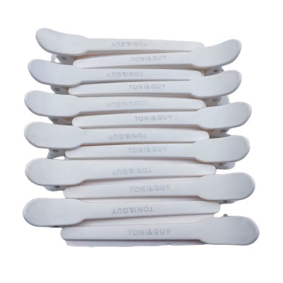 Conjunto de sete presilhas de cabelo brancas com texto TONI&GUY