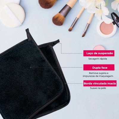 Toalha preta de microfibra dupla face com laço de suspensão e borda macia sobre fundo azul claro com pincéis e maquilhagem