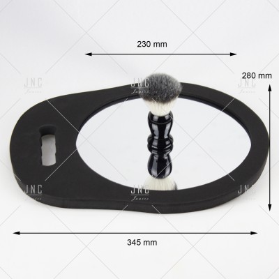 Espelho oval preto com pêlo de barbear no centro