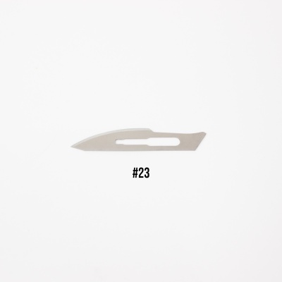 Lâmina de bisturi metálica número 23 sobre fundo branco