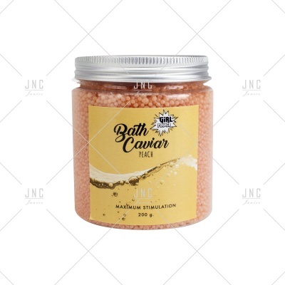 Frasco com esferas cor de pêssego para banho com rótulo amarelo Bath Caviar Peach
