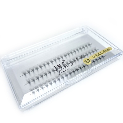 Estojos transparentes com pestanas negras agrupadas para extensão de pestanas