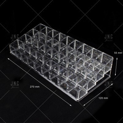 Organizador de acrílico transparente com 35 gavetas fotografado sobre fundo preto.