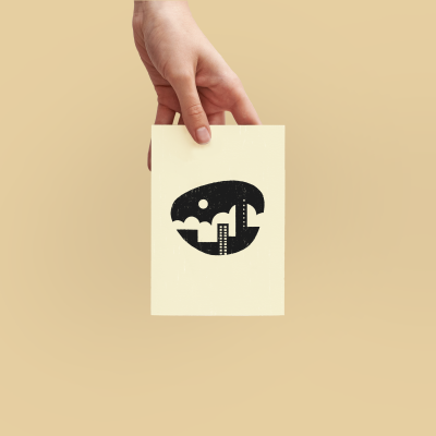 Cartão branco com desenho preto de cidade estilizada segurado por uma mão