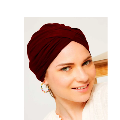 Mulher com turbante vermelho escuro e brinco de argola colorido