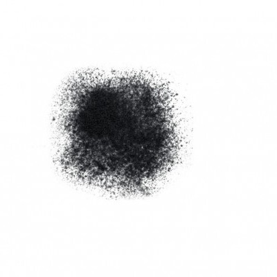 Pó preto granular disperso sobre fundo branco formando mancha