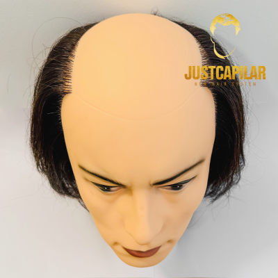 Cabeça de manequim com peruca castanha escura simulando calvície e logótipo JUSTCAPILAR.