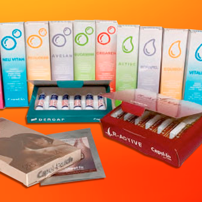 Produtos cosméticos CAMPOMED multicoloridos com caixas e frascos em fundo laranja