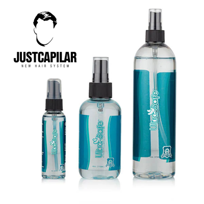 Três frascos de spray transparentes com líquido azul e texto UltraSafe, junto do logo JUSTCAPILAR.