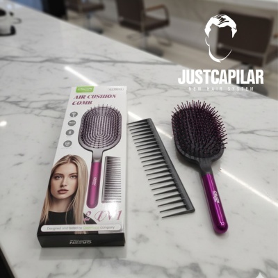 Escova de cabelo rosa air cushion com pente preto e embalagem, sobre bancada branca