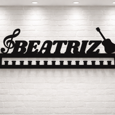 Suporte de parede preto em metal com a palavra BEATRIZ e elementos musicais