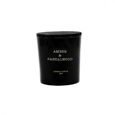 Vela perfumada preta com tampa e texto dourado