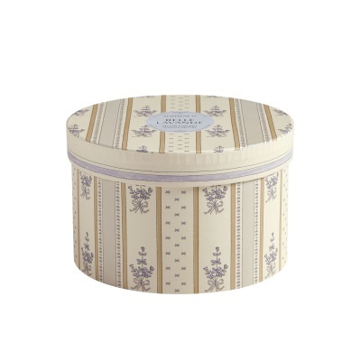 Caixa decorativa oval com padrão floral e listras em tons bege e lilás