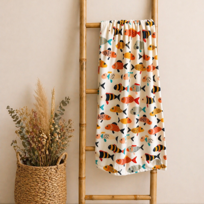 Manta branca com peixes coloridos pendurada em escada de bambu